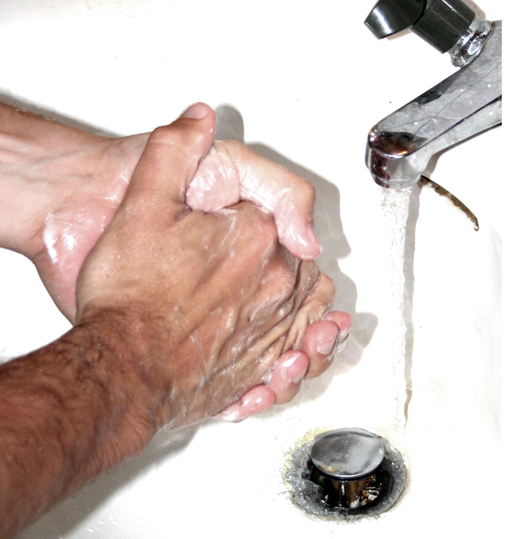 Hands being washed under running water