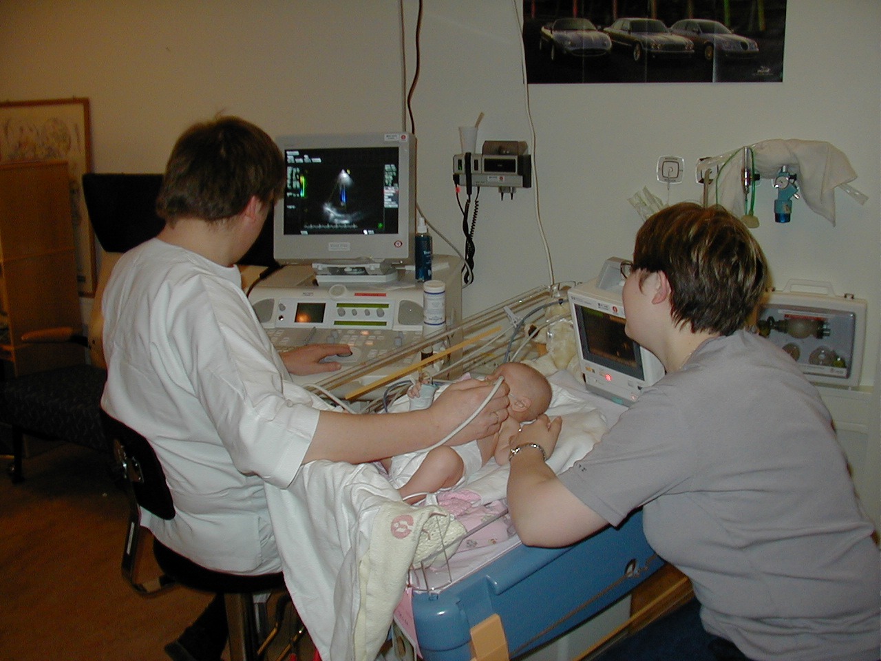 A sonographer performing pediatric echocardiography