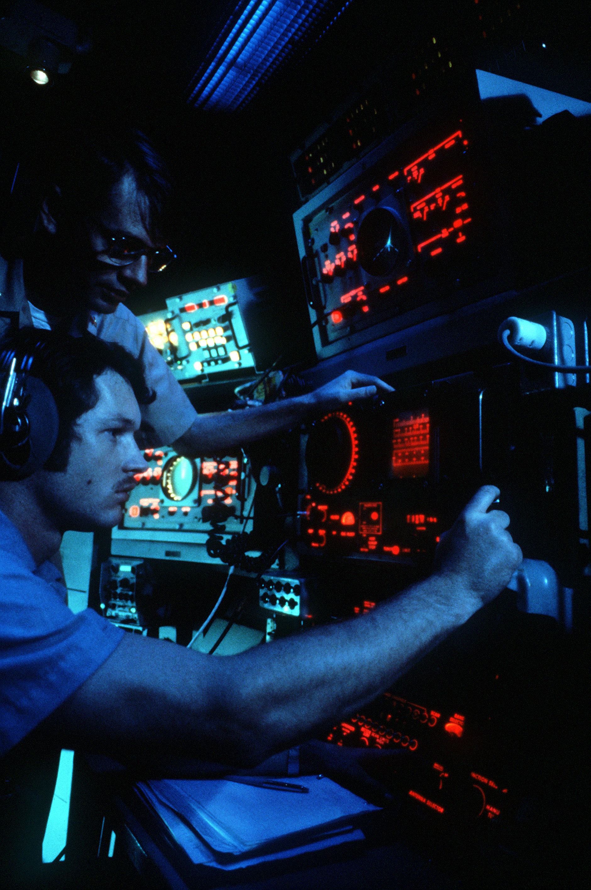 A crew member monitoring shipboard sonar equipment